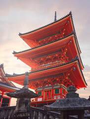 Fototapeta premium Sanjunoto Pagoda at Kiyomizu-dera in Kyoto, Japan, captured in warm vintage film tones with soft light emphasizing the red architectural details at sunset