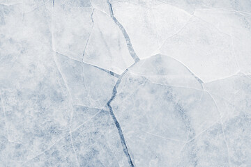 Cracked ice surface background texture with cracks in a light-blue tone.