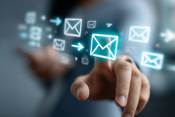 Macro conceptual image of a touch-based email interface, hands engaging with a virtual layer of glowing blue icons, email envelopes highlighted at the forefront surrounded by digit