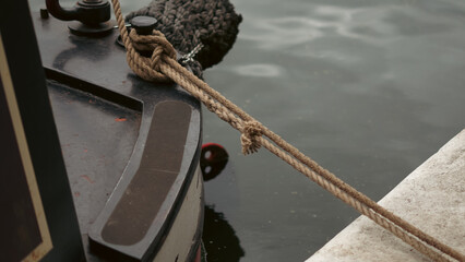 Nose of a boat floating calmly on a quiet river in scenic natural landscape