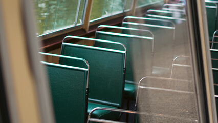 Close up view of a modern boat cabin with vivid green seats and marine details