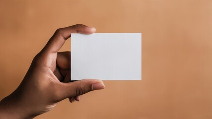 Hand Holding a Blank White Business Card Against a Warm Orange Background, Offering a Clean and Modern Template for Branding, Marketing, and Professional Contact Designs