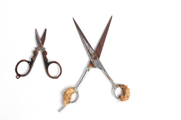 small scissors and barber scissors covered in rust wrapped in bandage isolated on white background