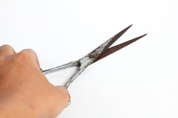 hand holding rusty barber scissors isolated on white background
