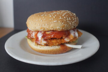 chicken katsu burger with vegetable and messed up sauce