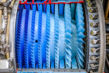 Detailed view of an airplane engine showcasing its complex turbine design and colorful components...