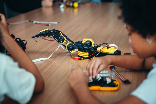 STEM Education Workshop With School Kid Learning Robotics and Programming From Engineer Teacher Using Robotic Kit and Laptop in a Creative Classroom