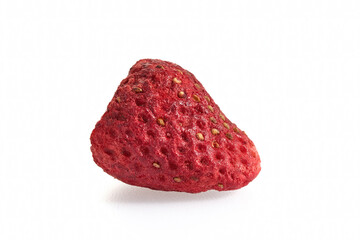 Close-up of a single freeze-dried strawberry against a white background