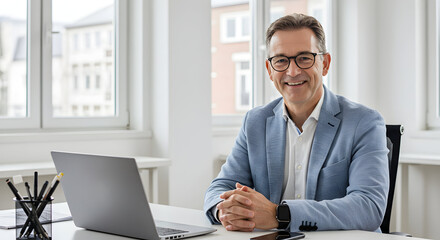 Confident businessman smiling at his desk in a modern office, ready for a productive workday ahead, showcasing success and professionalism.
