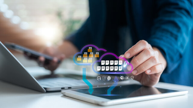 Businessman hand interacting with cloud data storage and cybersecurity interface on tablet. Concept of digital technology, cloud computing, and online file transfer.