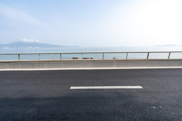 Fototapeta premium asphalt road side by sea