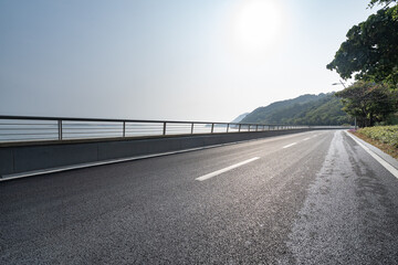 Fototapeta premium asphalt road side by sea