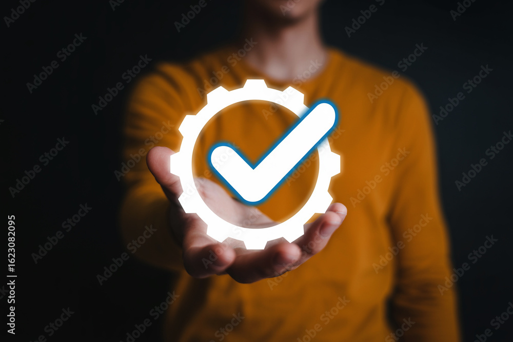 Aufkleber hand holding gear with check mark symbol representing process approval and completion certification 