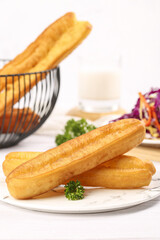 Delicious crispy large fries served on a white plate with fresh parsley and a healthy side of coleslaw