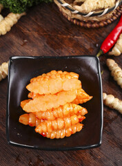 Freshly dug red oil ground silkworm ganoderma subs prepared for lower meals in a rustic kitchen...