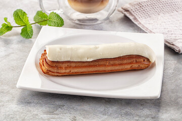 White vanilla eclair with icing