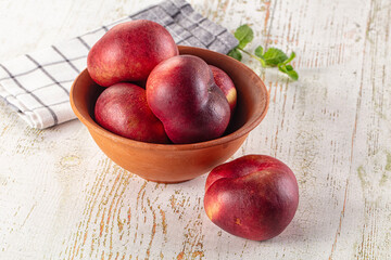 Ripe sweet juicy flat nectarines heap