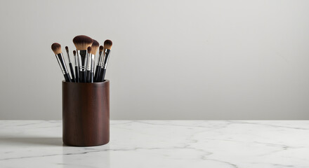 Elegant display of makeup brushes in a sleek wooden holder on marble surface