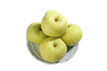 Fresh Tongchuan Crispy Pears stacked elegantly on a plate against a clean white background