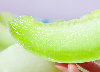 Fresh Southway Jade Mushroom Melon slice showcasing vibrant green flesh and reflective texture in...