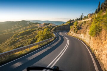 Winding Road Through a Picturesque Hilly Countryside at Sunrise, Offering a Scenic Journey with Lush Green Valleys and a Distant Village, Ideal for Travel, Adventure, and Nature Themes