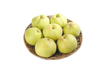 Fresh gunpowder pears displayed beautifully on a woven basket against a white background