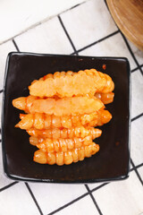 Fresh and crisp ground ring of pagoda cannellini served in a black dish on a checkered tablecloth