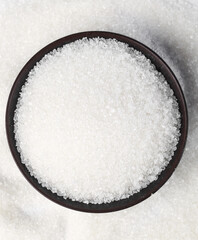 Yunnan sugar cane white sugar granulated in bowl on white background, showcasing texture and purity of natural sweetener