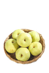 Fresh white crowned pears displayed in a woven basket against a clean white background