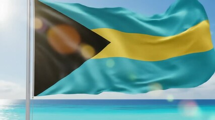 Bahamas flag waving proudly in the wind against a clear blue sky on a sunny day