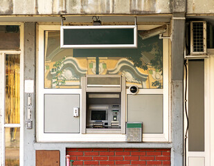 Bank ATM machine in building exterior outside on a street 