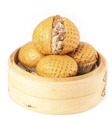 Delicious walnut buns sitting in a bamboo steamer with a rich filling displayed on a white...