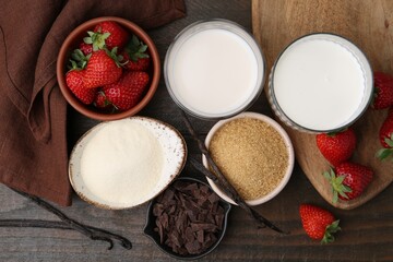 Different ingredients for panna cotta. Milk, sugar, vanilla, chocolate and strawberries on wooden table, flat lay