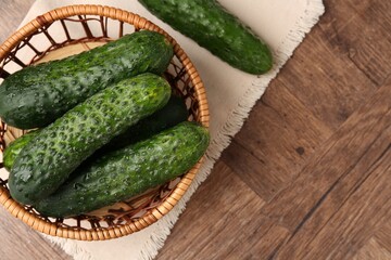 Fresh cucumbers on wooden table, flat lay