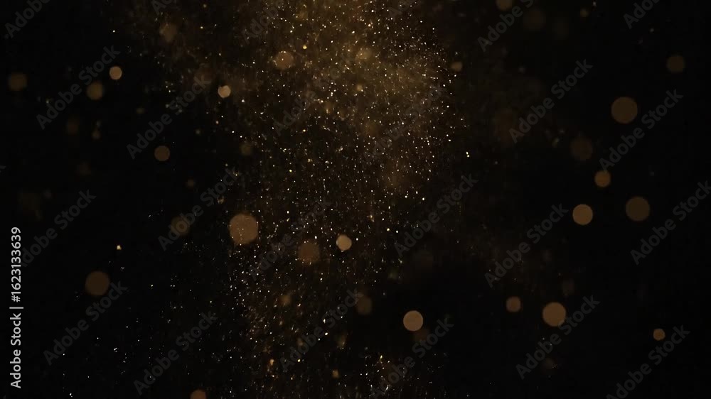 Poster Golden particles sparkle and shimmer falling on a dark background creating a magical abstract effect