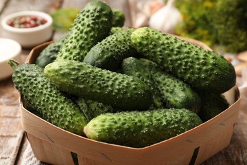 Making pickles. Fresh cucumbers and spices on wooden table, closeup