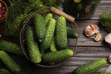 Making pickles. Fresh cucumbers and other ingredients on wooden table, flat lay