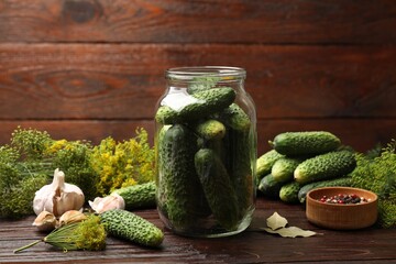 Making pickles. Fresh cucumbers and other ingredients on wooden table