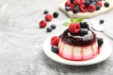 Gordijnen Tasty panna cotta with berries and jam on light grey table, closeup. Space for text © New Africa
