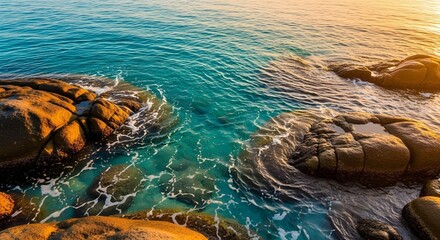 Aerial shot of choppy sea waters approaching a rocks