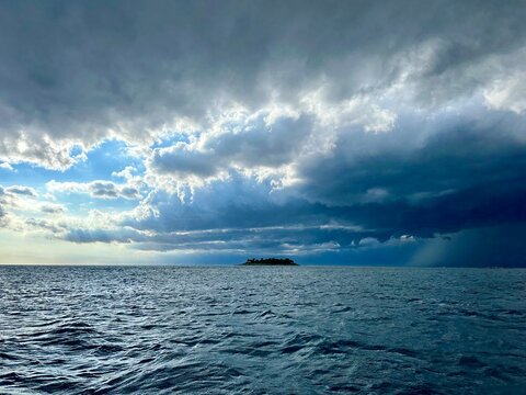 Storm clouds and rain over a small island in the Adriatic sea near Funtana, Istria, Croatia