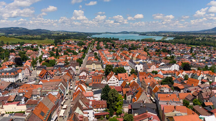 Aerial view of Fussen old town rooftops with Alps mountains on sunny summer day