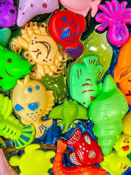 Full frame close-up of assorted multi coloured marine animal shaped Toys floating in water