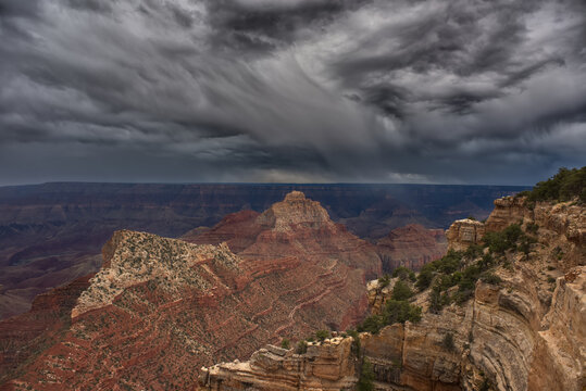Stormy grey skies over Freya's Castle Peak and Vishnu Temple in the Grand Canyon viewed from the North Rim, Arizona, USA