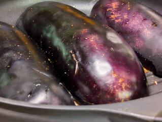 Cooking fresh eggplants in a skillet ready for a delicious meal preparation in the kitchen