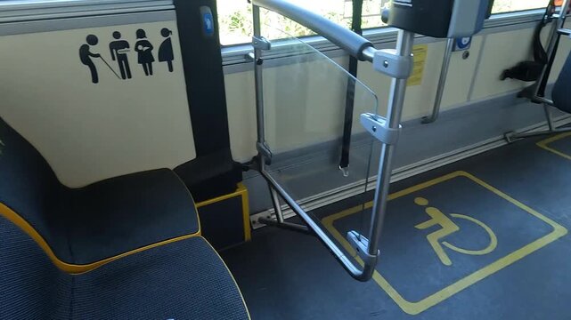 Interior of a Public Bus with Designated Seating for Disabled and Pregnant Passengers, Featuring Accessibility Features