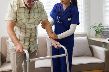 Caregiver, woman and helping with walker at nursing home for mobility support, physical therapy or hope for healing disability. Nurse, patient and physiotherapy for anatomy, balance or rehabilitation