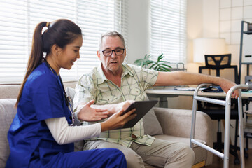 Attractive young woman in blue workwear nurse helping senior man in wheelchair with questionnaire, african american pensioneer filling papers at nursing home, having assistance
