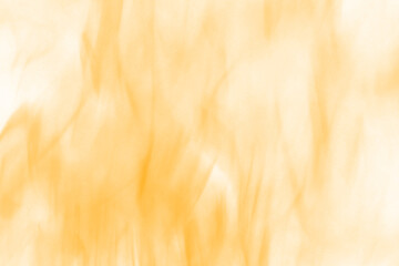 Abstract vertical flames of warm orange and yellow hues dancing in the darkness evoking heat and...