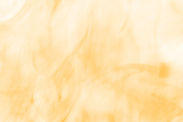 Abstract swirling patterns of warm golden and amber hues create a mesmerizing visual texture...